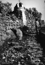 Vista de la desapareguda capelleta existent damunt un marge de pedra seca al camí de la capella de la Guia a la torre de Santa Caterina, els anys vint del segle XX. 
Procedència: Arxiu Jaume Pons i Agulló.