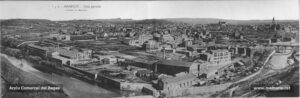 Perspectiva general de la ciutat de Manresa, obtinguda des de l'indret conegut amb el nom de Bellavista, els anys vint del segle passat. S'hi pot comprovar amb una resolució perfecta el perímetre urbà i l'extensió periurbana de la ciutat. Les inconfusibles xemeneies són testimoni del passat eminentment idustrial de la ciutat, xemeneies que alternen de manera genuïna amb els llocs de culte com la Cova, la Seu i el Carme, de dreta a esquerra respectivament. En el camí que menava a Joncadella, la torre de cal Viñas, ubicada expressament en un indret que fos localitzat des de qualsevol racó de la ciutat. A l'extrem esquerra i vorejant el riu, es poden observar les instal·lacions del gasòmetre, situades a l'inici de l'atual carrer de Frances Moragas, a l'oest del passeig del Riu. La fàbrica del gas va ser aixecada l'any 1859 al punt conegut pel molí d'en Travessa. Aquest sector de la ciutat s'havia començat a urbanitzar durant el darrer quart del segle XIX, gràcies a l'alineament de carrers perpendiculars a la carretera de Cardona, com el carrer del Bruc. Un cop entrats els anys vint del segle passat, tanmateix, l'alternança de fàbriques (la farinera "La Florinda" al mig de la perspectiva) i horts continuava encara caracteritzant l'evolució urbanística de la ciutat. Immediatament a continuació s'observa la històrica fàbrica del Panyos, dedicada en aquells moments a la fabricació de vetes de cotó, a càrrec de la societat Portabella i Cia. A tocar de la fàbrica del gas, la "Bonamossa" o fàbrica Carné. Al costat mateix, la farinera Albareda. 
Procedència: Arxiu Comarcal del Bages