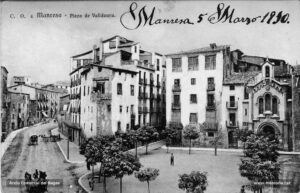 La plaça de Valldaura l'any 1910. A l'esquerra, la casa Morros, d'estil modernista, projectada per l'arquitecte Ignasi Oms i Ponsa. La plaça va ser urbanitzada l'any 1897 quan s'enderrocà l'antiga capella de Valldaura. Però el seu aspecte no complaïa al periodista Aureli Comas, qui el 1925 assegurava en to disconforme que «la plaça de Valldaura és l'única de Manresa, pel que veiem, que es vana de posseir un jardí o cosa semblant, molt ensopida i bruta de pols que a cada moment hi envien els nombrosos automòbils que hi passen el davant. La plaça de Valldaura és una equivocació. Guaiteu només com es fa difícil de travessar-la i el mal gust de la disposició de les plantes que fan riure més que res. Al mig, no hi ha cap monument, però sí un "parterre" de mona de Pasqua, que prou fa els últims badalls corsecat pel vent i per la pols i l'escassedat d'aigua que només deu tastar quan plou. Millor seria que es treguessin els arbrissons i s'hi posessin arbres de debò, alguns plàtans potser, els quals almenys podrien resistir la pols i no tocarien el ridícol».
Procedència: Arxiu Comarcal del Bages