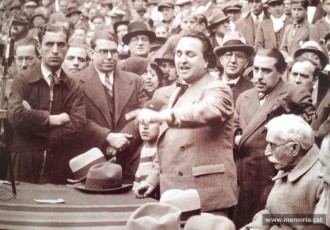 12/11/1933. Ramon Junyent, en segon pla i primer per l’esquerra, en un míting a la Monumental durant la campanya de les eleccions legislatives, amb Ventura Gassol i el president Francesc Macià. (Família Junyent).